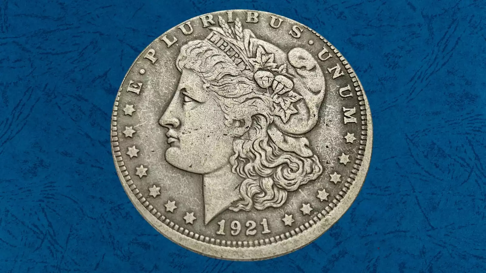 1921 Morgan dollar off-center strike error showing design shifted and partial rim missing from misaligned planchet